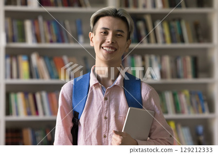 Portrait smiling student guy holding digital tablet looking at camera Portrait smiling student guy holding digital tablet looking at camera 129212333