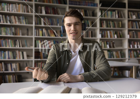 Webcam portrait confident young man distance learning student in headphones Webcam portrait confident young man distance learning student in headphones 129212379