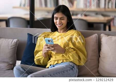 Indian worker or student woman using her smartphone during break Indian worker or student woman using her smartphone during break 129212429