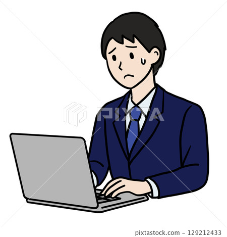 A man with a troubled expression working on a computer 129212433