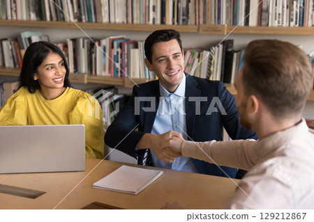Group of businesspeople shaking hands, conclude agreement 129212867