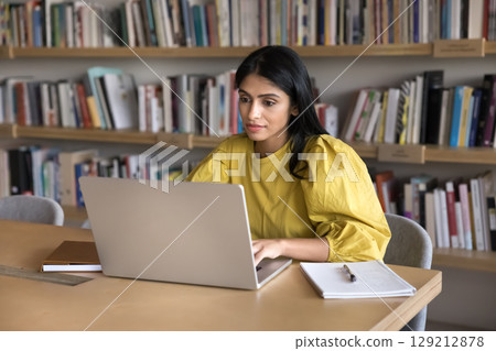 Young Indian woman employee or student working on laptop Young Indian woman employee or student working on laptop 129212878