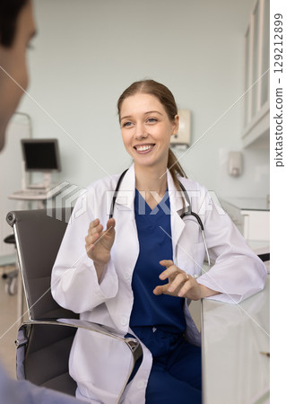 Positive optimistic general practitioner woman giving medical recommendation to patient Positive optimistic general practitioner woman giving medical recommendation to patient 129212899