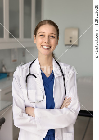 Happy physician woman in lab coat posing for profile picture Happy physician woman in lab coat posing for profile picture 129213029
