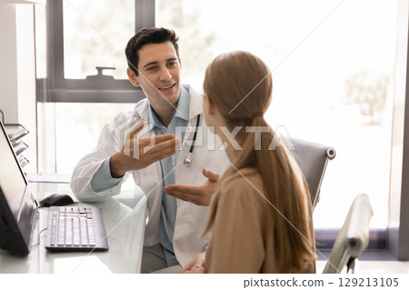 Positive young Hispanic healthcare professional man giving advice to patient Positive young Hispanic healthcare professional man giving advice to patient 129213105