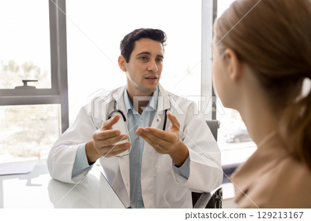 Handsome Latin general practitioner man giving medical advice to patient 129213167