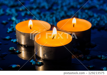 Lovely photo of three burning candles Lovely photo of three burning candles 129213575