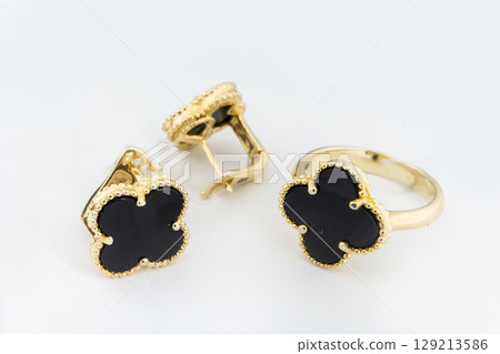 Gold jewelry set of ring and gold earrings with stones on white background. Gold jewelry set collection Gold jewelry set of ring and gold earrings with stones on white background. Gold jewelry set collection 129213586