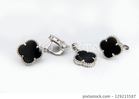 Silver jewelry set of ring and silver earrings with stones on white background. Silver jewelry set collection 129213587