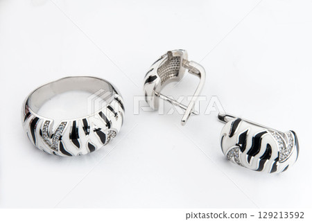 Silver jewelry set of ring and silver earrings with stones on white background. Silver jewelry set collection Silver jewelry set of ring and silver earrings with stones on white background. Silver jewelry set collection 129213592