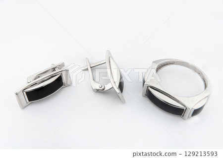 Silver jewelry set of ring and silver earrings with stones on white background. Silver jewelry set collection Silver jewelry set of ring and silver earrings with stones on white background. Silver jewelry set collection 129213593