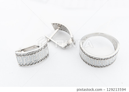 Silver jewelry set of ring and silver earrings with stones on white background. Silver jewelry set collection Silver jewelry set of ring and silver earrings with stones on white background. Silver jewelry set collection 129213594