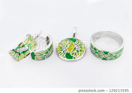 Silver jewelry set of ring and silver earrings with stones on white background. Silver jewelry set collection Silver jewelry set of ring and silver earrings with stones on white background. Silver jewelry set collection 129213595