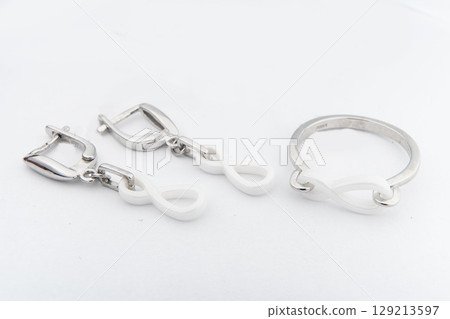 Silver jewelry set of ring and silver earrings with stones on white background. Silver jewelry set collection Silver jewelry set of ring and silver earrings with stones on white background. Silver jewelry set collection 129213597