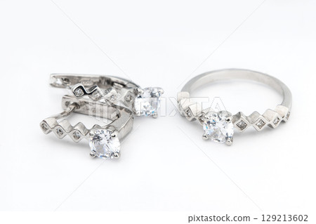 Silver jewels collection with crystals in minimalism style. Silver set of earrings and silver necklace Silver jewels collection with crystals in minimalism style. Silver set of earrings and silver necklace 129213602