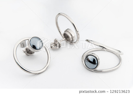 Silver jewels collection with crystals in minimalism style. Silver set of earrings and silver necklace Silver jewels collection with crystals in minimalism style. Silver set of earrings and silver necklace 129213623