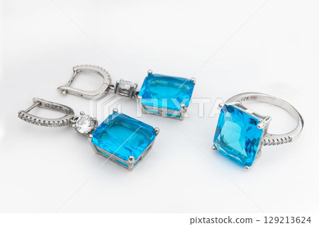 Silver jewels collection with crystals in minimalism style. Silver set of earrings and silver necklace Silver jewels collection with crystals in minimalism style. Silver set of earrings and silver necklace 129213624