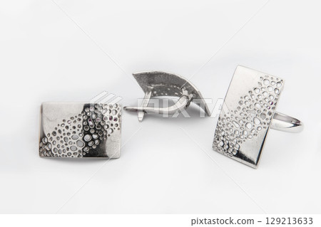 Silver jewelry set of ring and silver earrings with stones on white background. Silver jewelry set collection 129213633