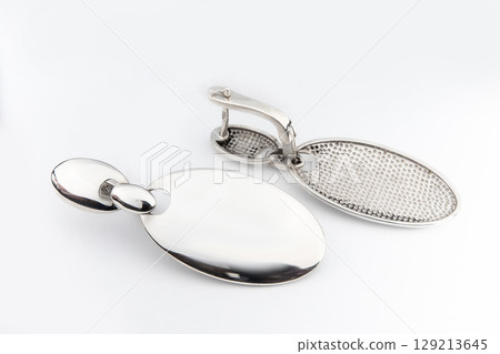 Luxury silver round earrings big jewelry for women isolated on white background, clipping path included Luxury silver round earrings big jewelry for women isolated on white background, clipping path included 129213645