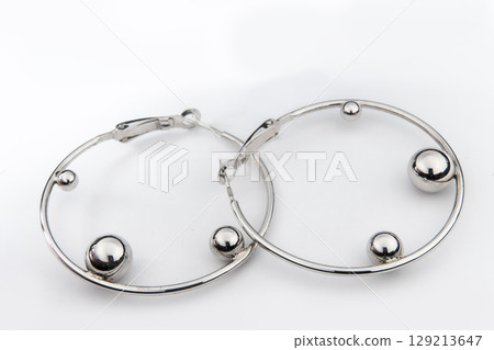 Luxury silver round earrings big jewelry for women isolated on white background, clipping path included Luxury silver round earrings big jewelry for women isolated on white background, clipping path included 129213647