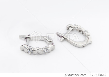 Luxury silver round earrings big jewelry for women isolated on white background, clipping path included Luxury silver round earrings big jewelry for women isolated on white background, clipping path included 129213662