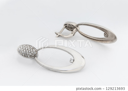 Luxury silver round earrings big jewelry for women isolated on white background, clipping path included Luxury silver round earrings big jewelry for women isolated on white background, clipping path included 129213693