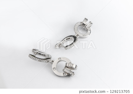 Luxury silver round earrings big jewelry for women isolated on white background, clipping path included Luxury silver round earrings big jewelry for women isolated on white background, clipping path included 129213705