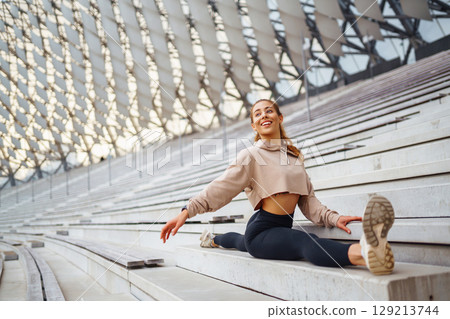 A young female athlete in special clothing is training on the court. Concept of sport, health. 129213744