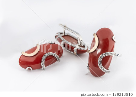 Elegant jewelry set of white gold ring, necklace and earrings with diamonds. Silver jewellery set with gemstones. Product still life concept Elegant jewelry set of white gold ring, necklace and earrings with diamonds. Silver jewellery set with gemstones. Product still life concept 129213810