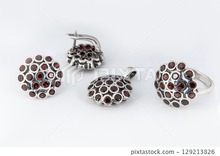 Elegant jewelry set of white gold ring, necklace and earrings with diamonds. Silver jewellery set with gemstones. Product still life concept Elegant jewelry set of white gold ring, necklace and earrings with diamonds. Silver jewellery set with gemstones. Product still life concept 129213826