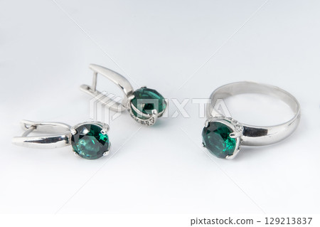 Elegant jewelry set of white gold ring, necklace and earrings with diamonds. Silver jewellery set with gemstones. Product still life concept 129213837