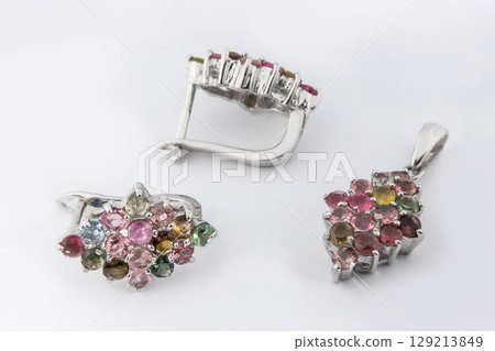 Elegant jewelry set of white gold ring, necklace and earrings with diamonds. Silver jewellery set with gemstones. Product still life concept Elegant jewelry set of white gold ring, necklace and earrings with diamonds. Silver jewellery set with gemstones. Product still life concept 129213849
