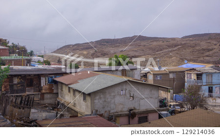 View of Tijuana, near the U.S.-Mexico border, with weathered homes and arid hills, emphasizing border security, immigration tensions, and economic hardship. View of Tijuana, near the U.S.-Mexico border, with weathered homes and arid hills, emphasizing border security, immigration tensions, and economic hardship. 129214036