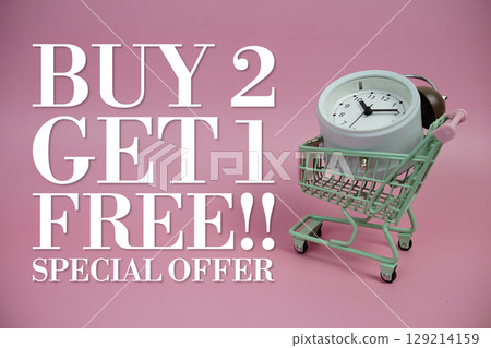 Buy 2 Get 1 Free!! Promotion and Marketing with trolley shopping cart and alarm clock on pink background Buy 2 Get 1 Free!! Promotion and Marketing with trolley shopping cart and alarm clock on pink background 129214159
