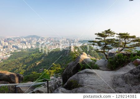 Seoul cityscape in the afternoon and Dongdaemun skyscrapers with Namsan Mountain in the background, Seoul, South Korea. Seoul cityscape in the afternoon and Dongdaemun skyscrapers with Namsan Mountain in the background, Seoul, South Korea. 129214381