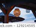Wicker lamps under the roof of an open beach bar. Craft and handmade atmosphere. 129214505