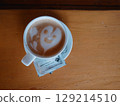 A cup of cappuccino with a smiley latte art awaits visitors at the bar. Ordering 129214510