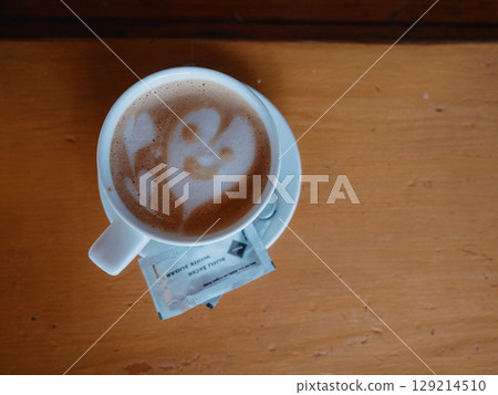A cup of cappuccino with a smiley latte art awaits visitors at the bar. Ordering 129214510