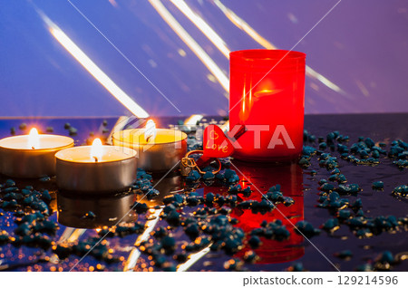 In the candlelight, the golden ring appears especially festive and precious In the candlelight, the golden ring appears especially festive and precious 129214596