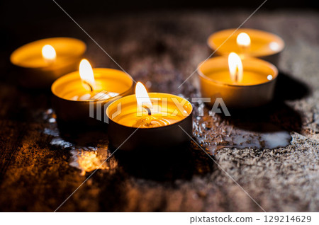 Many burning candles create a magical backdrop 129214629