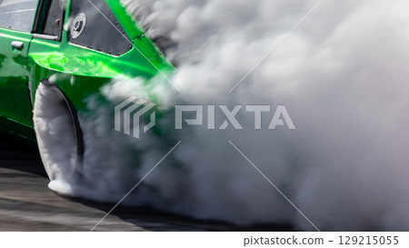 Car drifting, Blurred image diffusion race drift car with lots of smoke from burning tires on speed track, Car drifting on speed track, Professional driver drive drifting car. 129215055