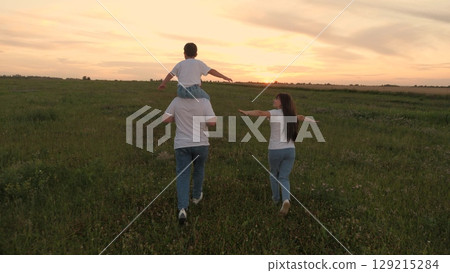 group people running green meadow field, mother father child kid son running green grass, family summer sunset, cheerful woman man playing child sunset, children dream playing airplane pilot, little group people running green meadow field, mother father child kid son running green grass, family summer sunset, cheerful woman man playing child sunset, children dream playing airplane pilot, little 129215284