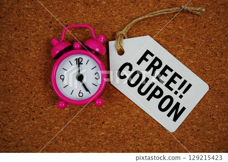Free Coupon text on price tag with alarm clock on cork board background Free Coupon text on price tag with alarm clock on cork board background 129215423