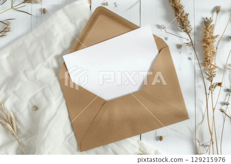 A typical brown envelope containing a separate white card inside of it. AI-generated content. 129215976