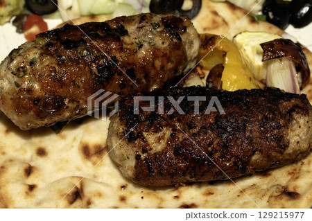 Close up of juicy lamb kofta kebab on a flatbread Close up of juicy lamb kofta kebab on a flatbread 129215977