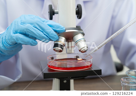 Scientist medical professional use microscope for research in science laboratory. Scientist medical professional use microscope for research in science laboratory. 129216224