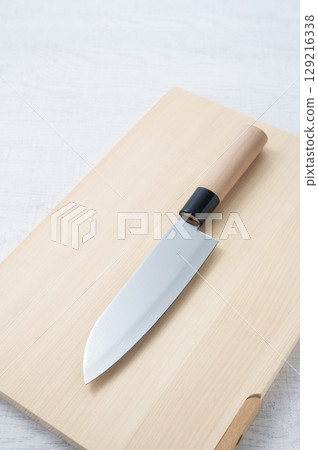 A knife placed on a cutting board A knife placed on a cutting board 129216338