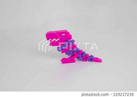 Colorful plastic dragon toy on a white background. The concept of the Chinese New Year 129217230