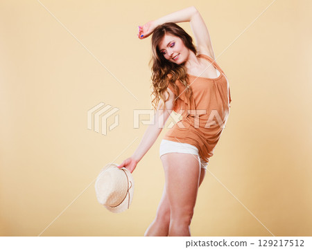Lovely girl in summer clothes straw hat Lovely girl in summer clothes straw hat 129217512
