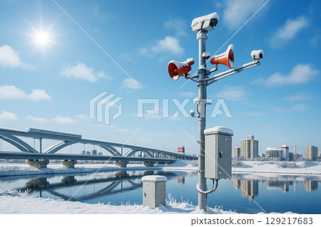 Disaster prevention administrative radio chime and Nippori-Toneri Liner on the snowy bank of the Arakawa River 129217683